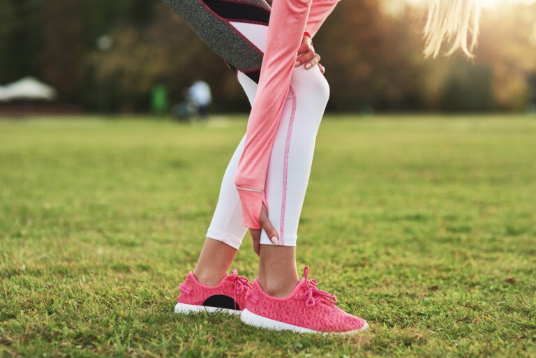 Close up of sporty woman suffering from calf pain