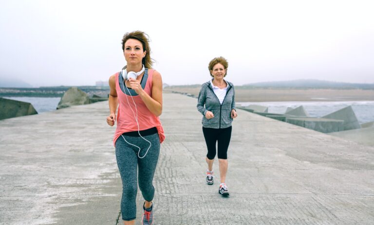 Senior and young sportswoman running